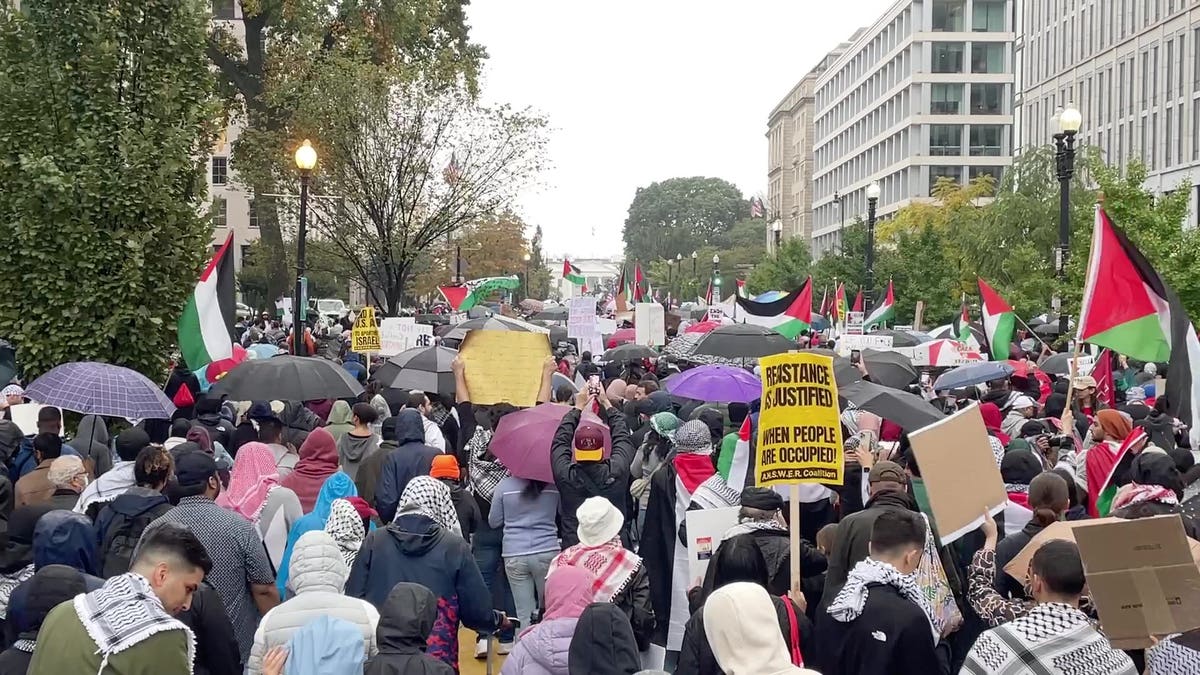 Protesters march through Black Lives Matter Plaza toward the White House.