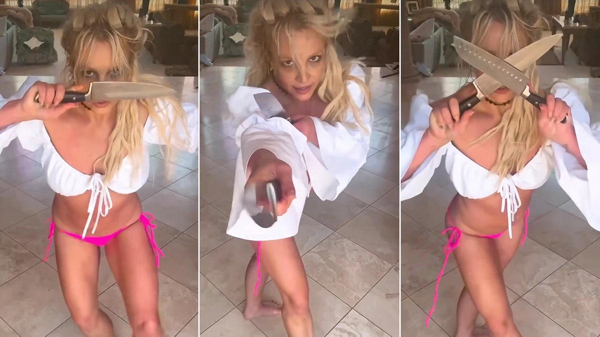 Britney Spears in a pink bikini and white top handles prop knives