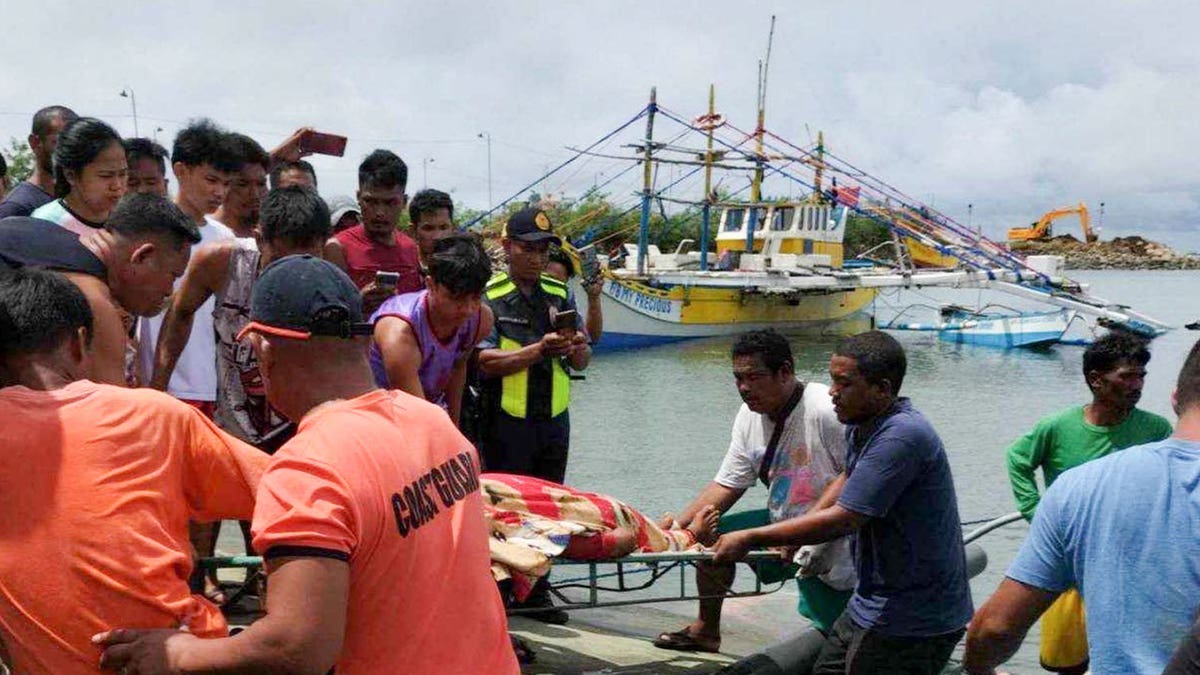 crew carries body at port