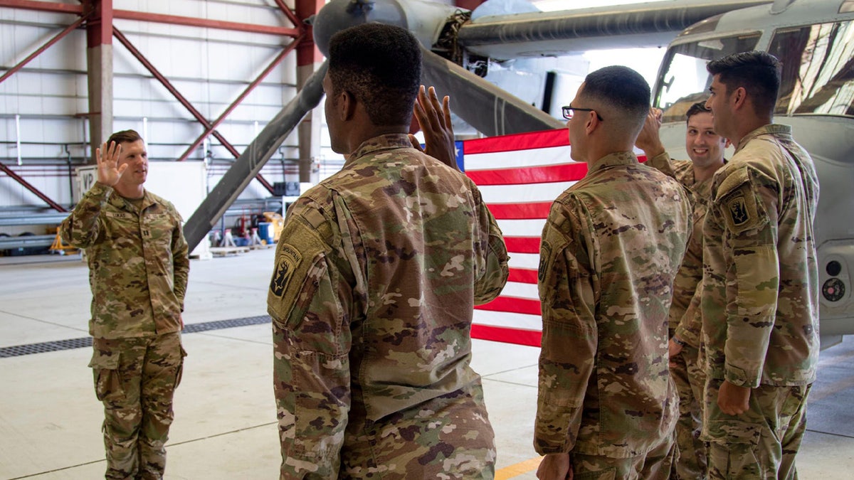Three soldiers raise right hands to reenlist in Connecticut Army National Guard