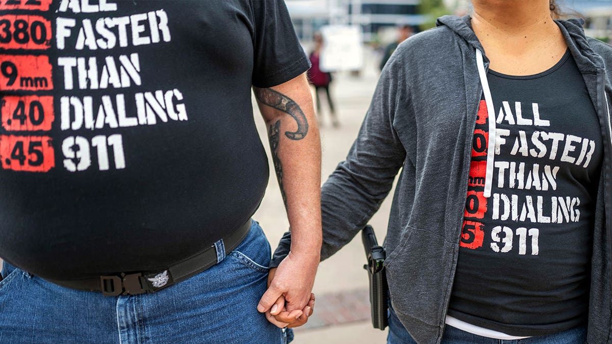 couple wears anti-gun shirts