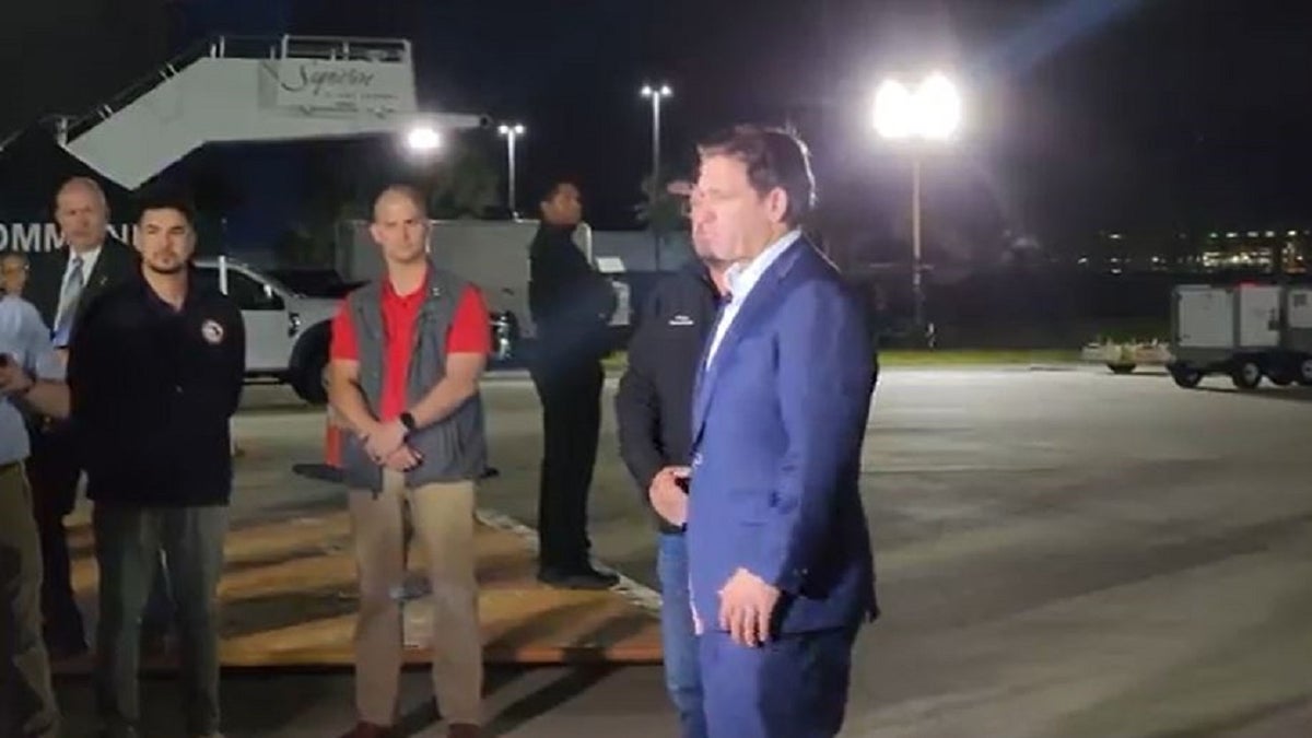 Florida Gov. Ron DeSantis greets passengers from Israel on the tarmac in Tampa