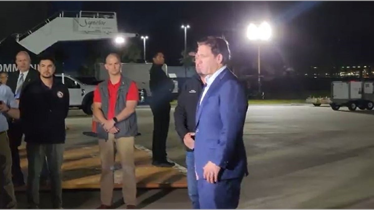 Florida Gov. Ron DeSantis greets passengers from Israel on the tarmac in Tampa