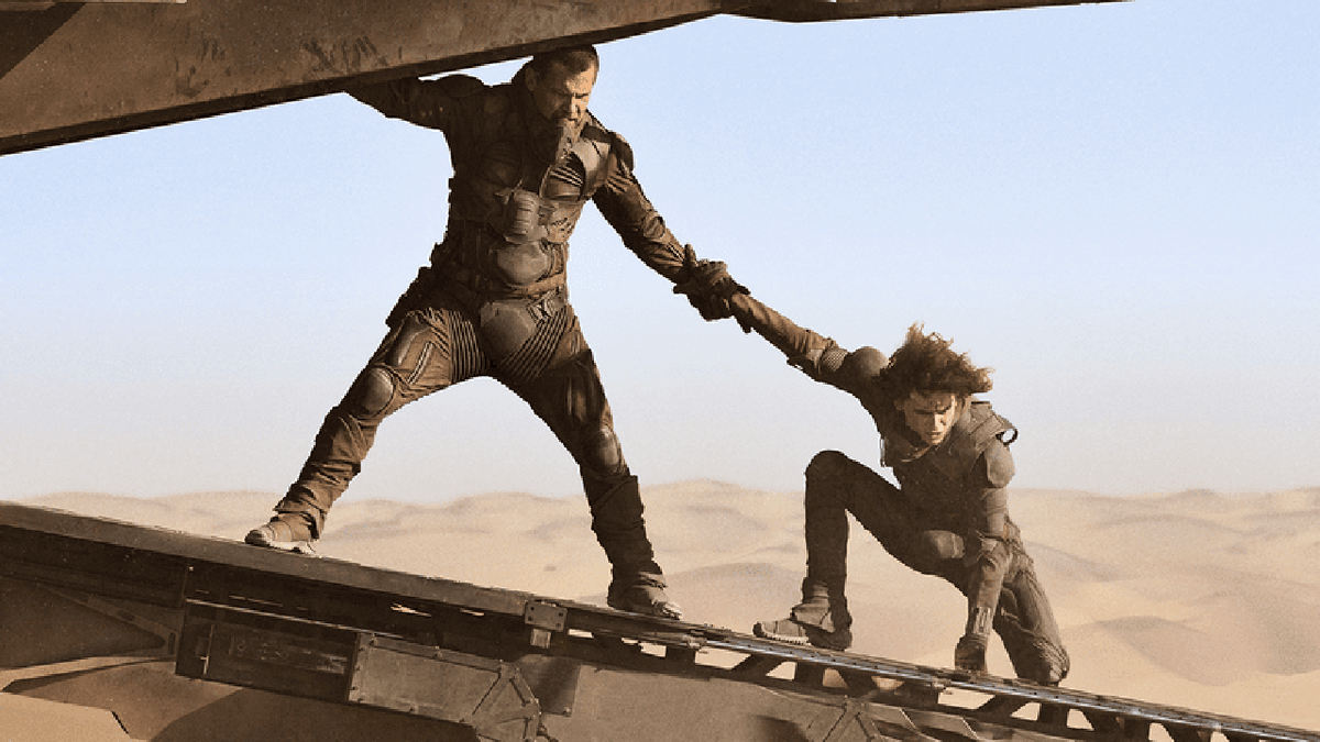 Josh Brolin and Timothée Chalamet balance on a plane wing in a scene from "Dune."