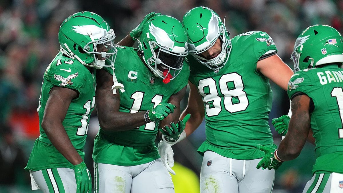 3 Eagles players celebrate touchdown