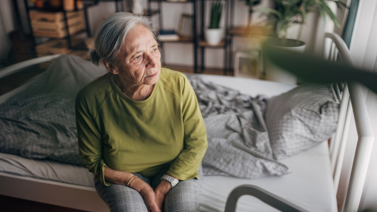 Elderly woman on bed