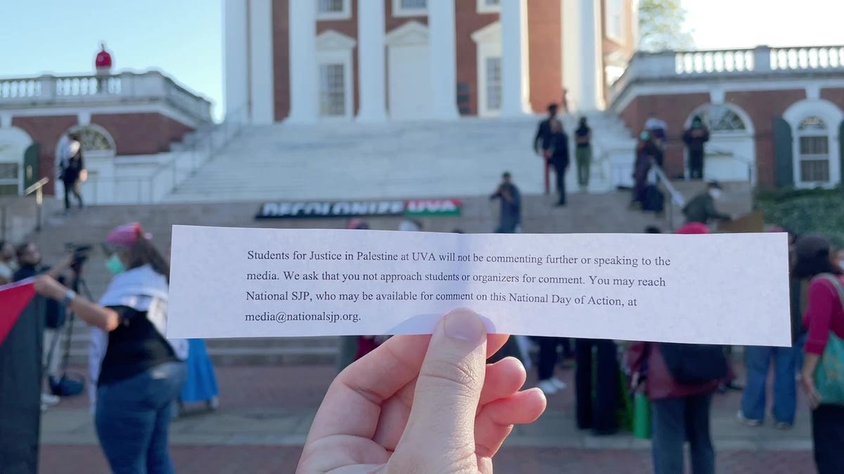 A paper notice distributed at the SJP UVA event asking reporters not to interview rally attendees. 