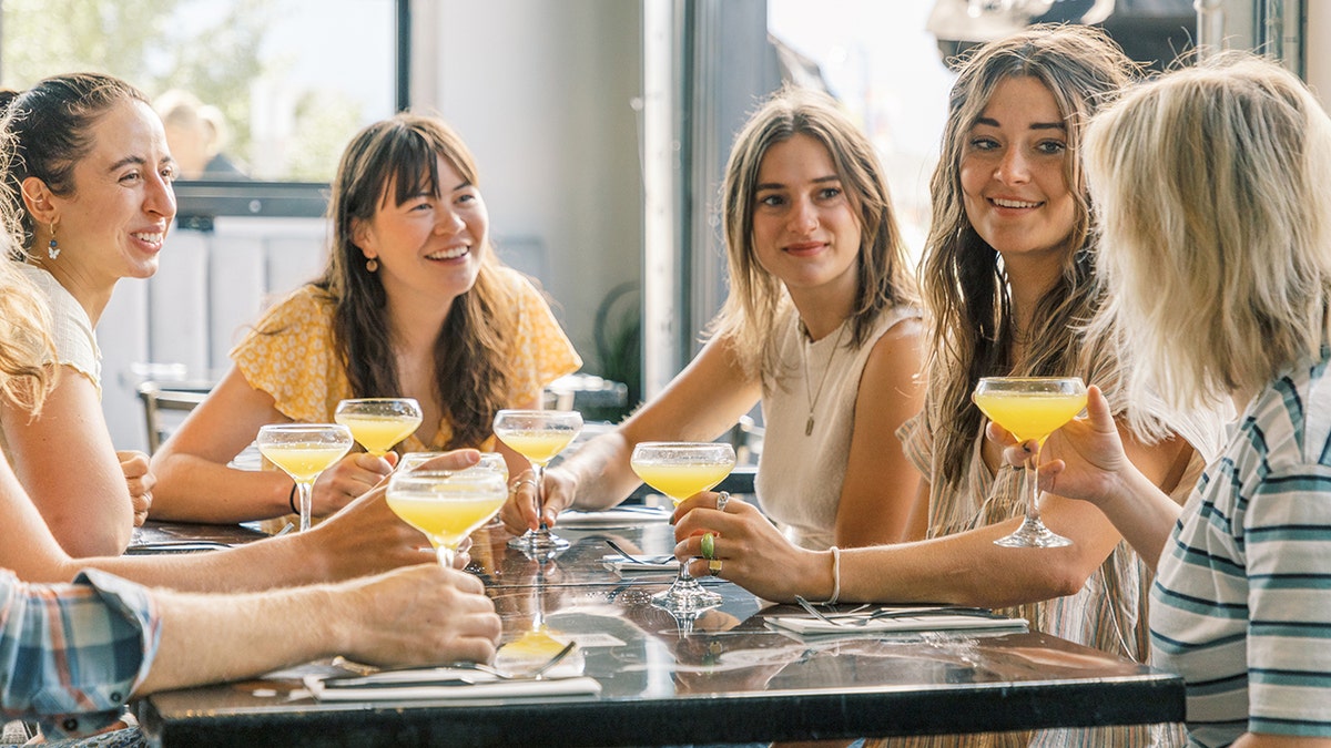 girls drinking mimosas at brunch
