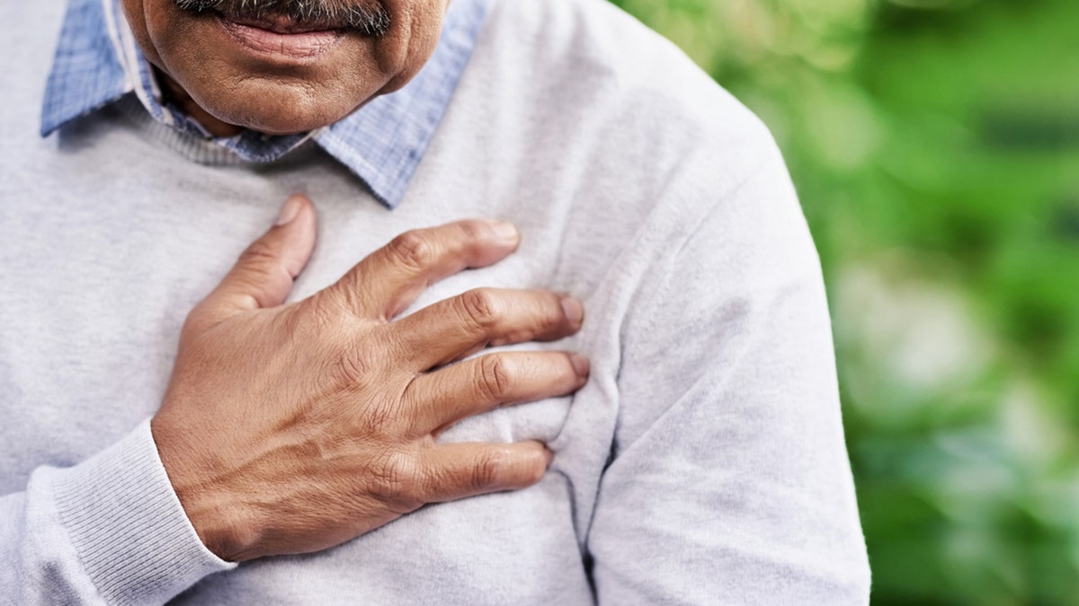 man holding chest