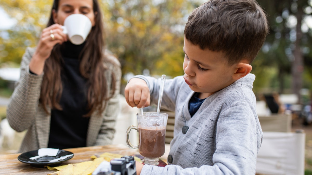 boy stirring hot chocolate