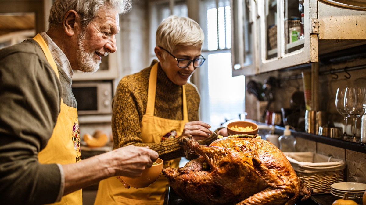 couple preparing turkey