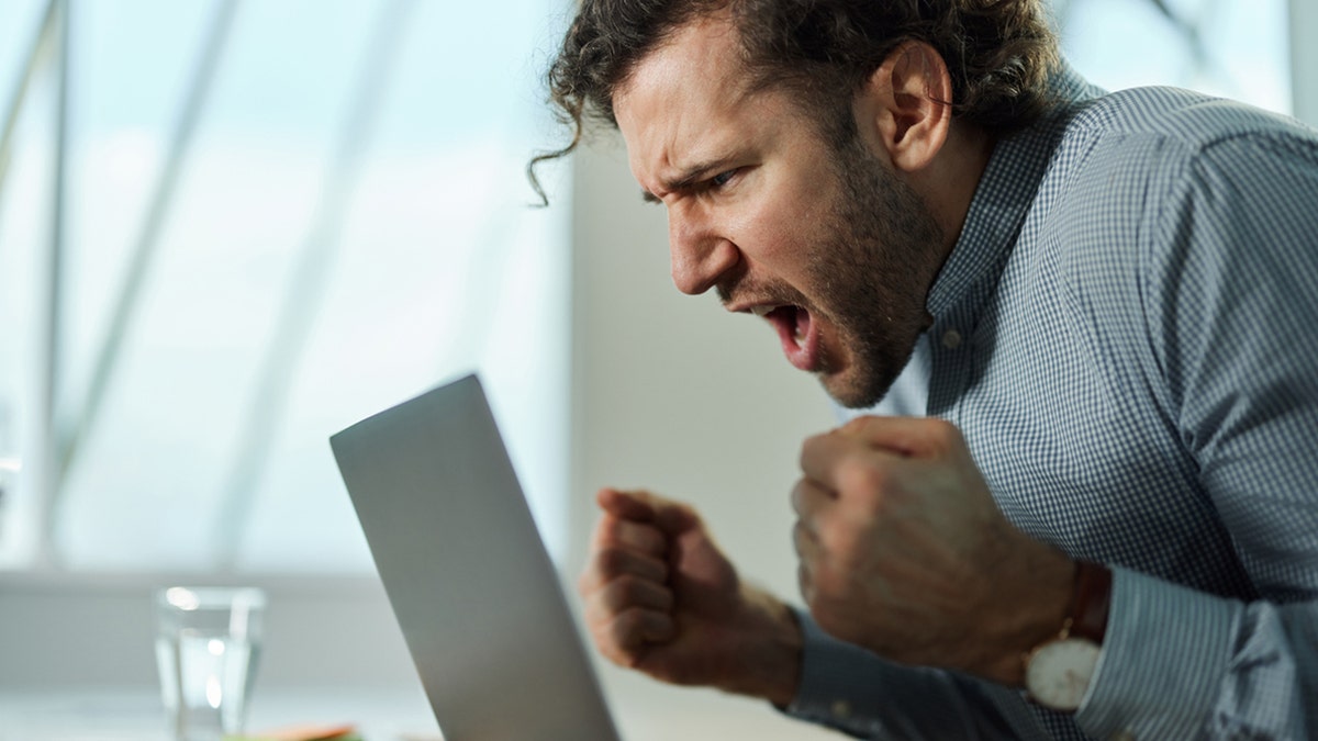 man angry at laptop