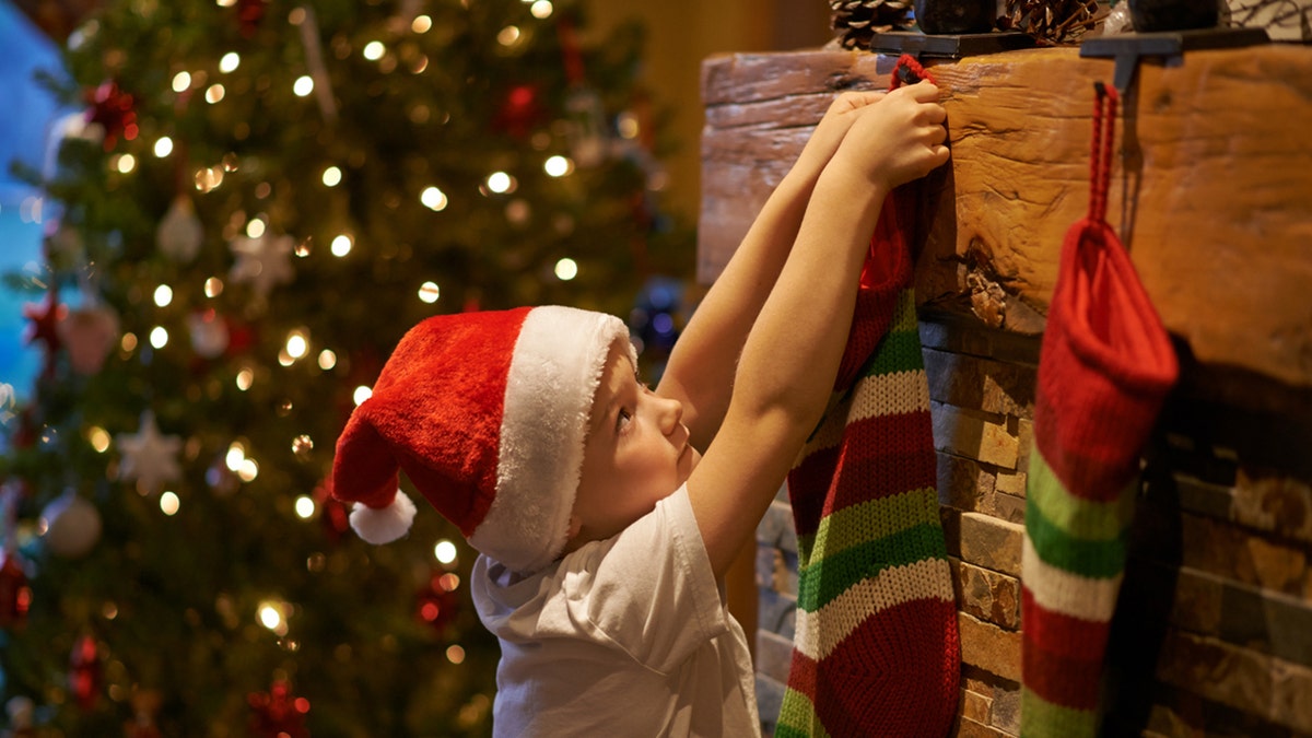 little boy hanging stocking