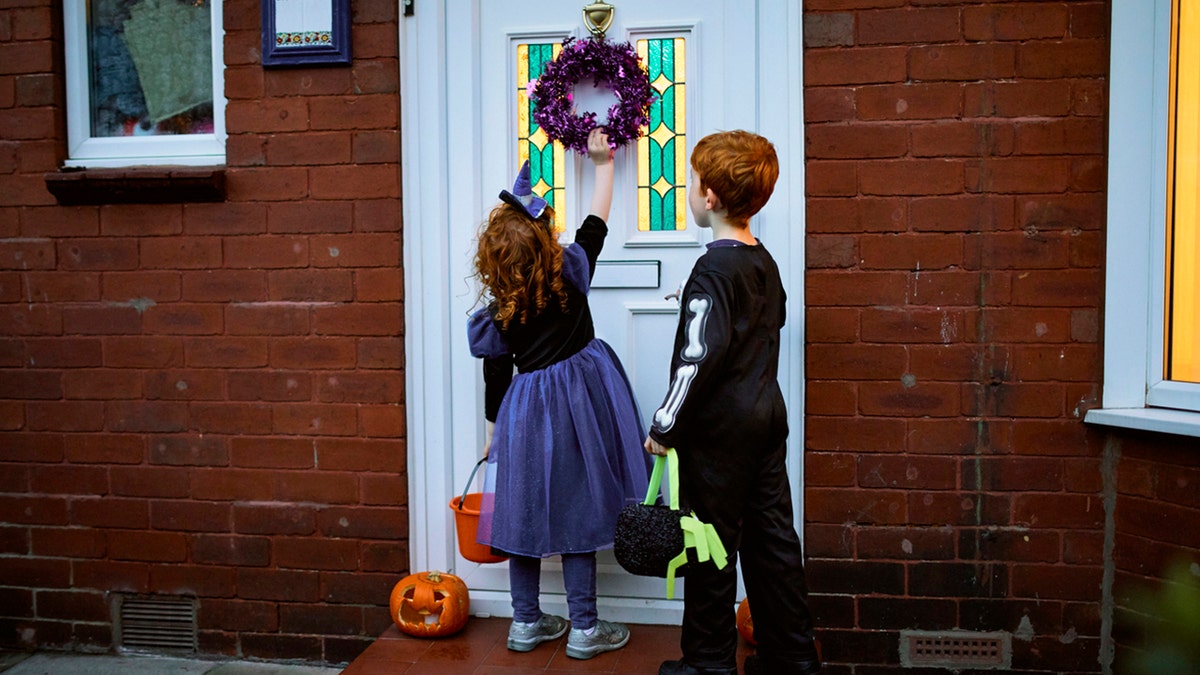 kids in costume knocking on door