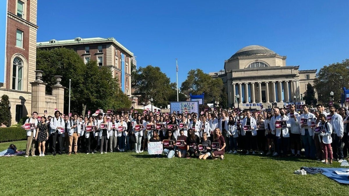 Columbia University students protest in white coats