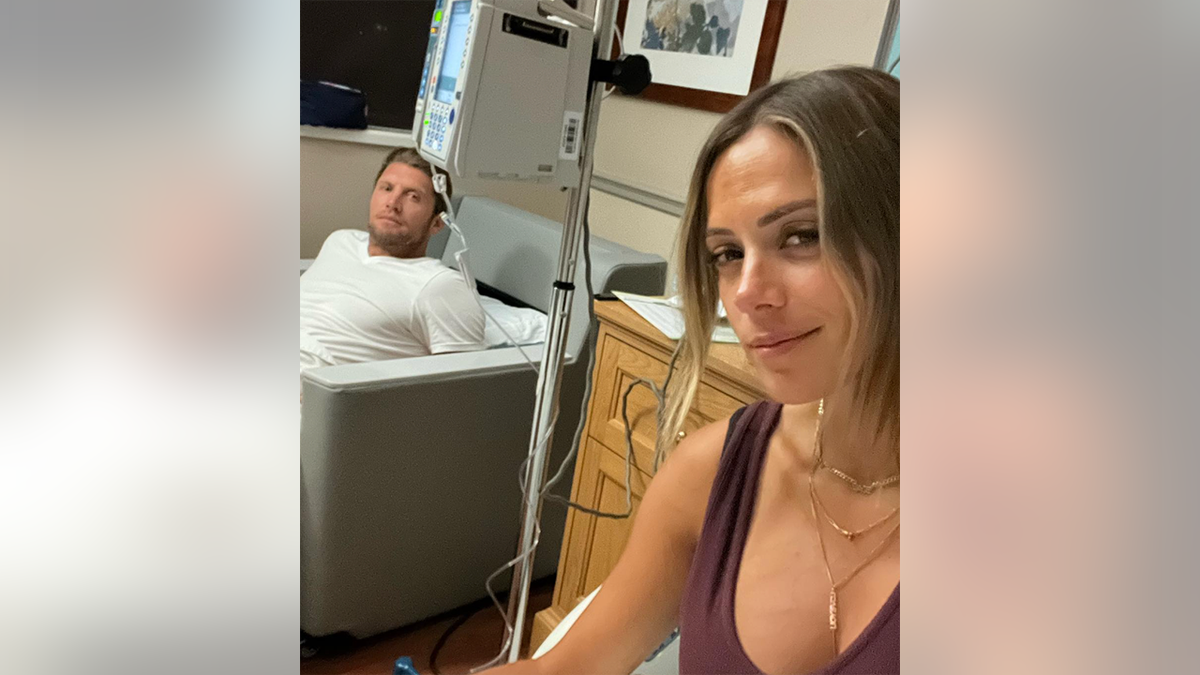 Jana Kramer and her fiancé Allan Russell look solemn in the hospital