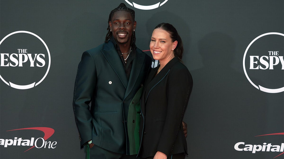 Jrue and Lauren Holiday pose for photo