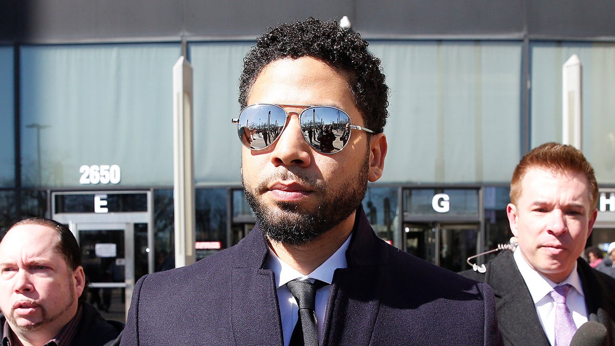 Jussie Smollett leaves Chicago courthouse wearing sunglasses and blue trenchcoat