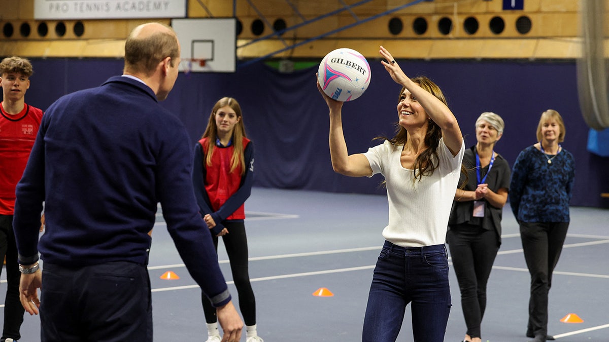 Kate shooting a ball into a net