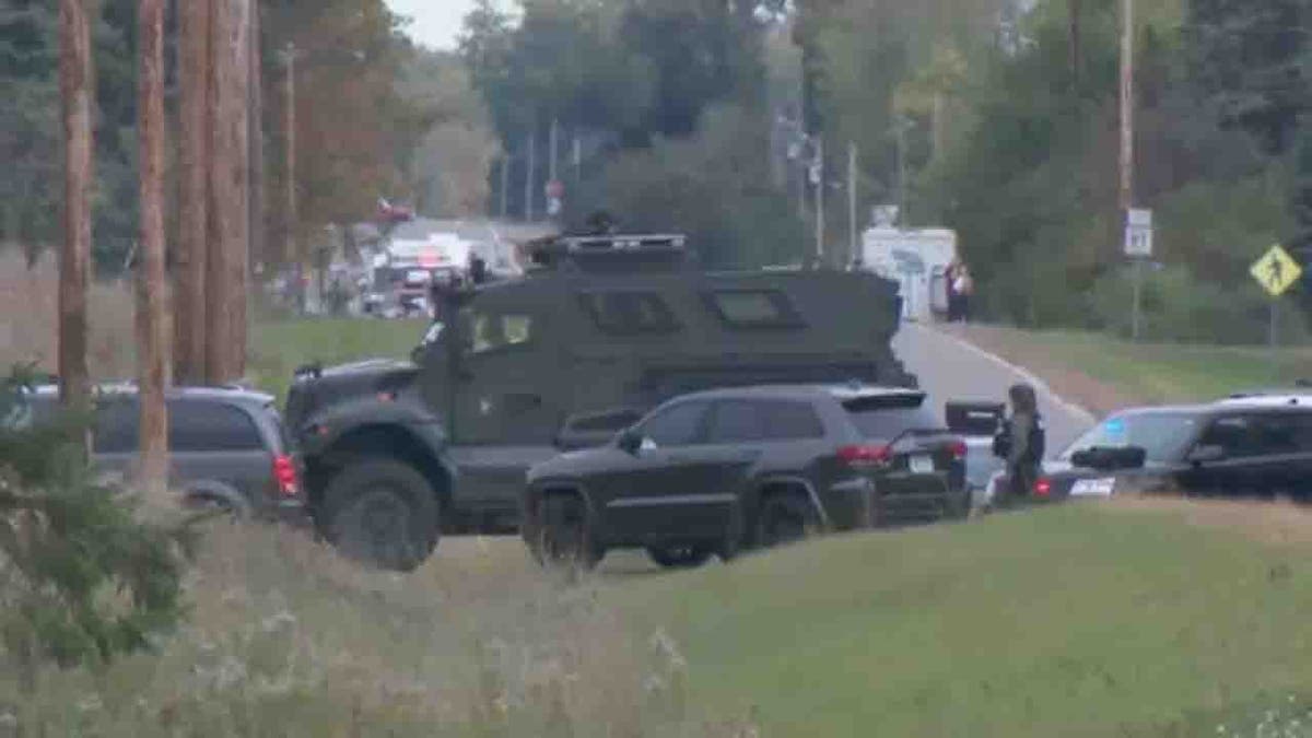Five Minnesota officers shot while serving warrant, suspect in custody police vehicles and officers in tactical gear