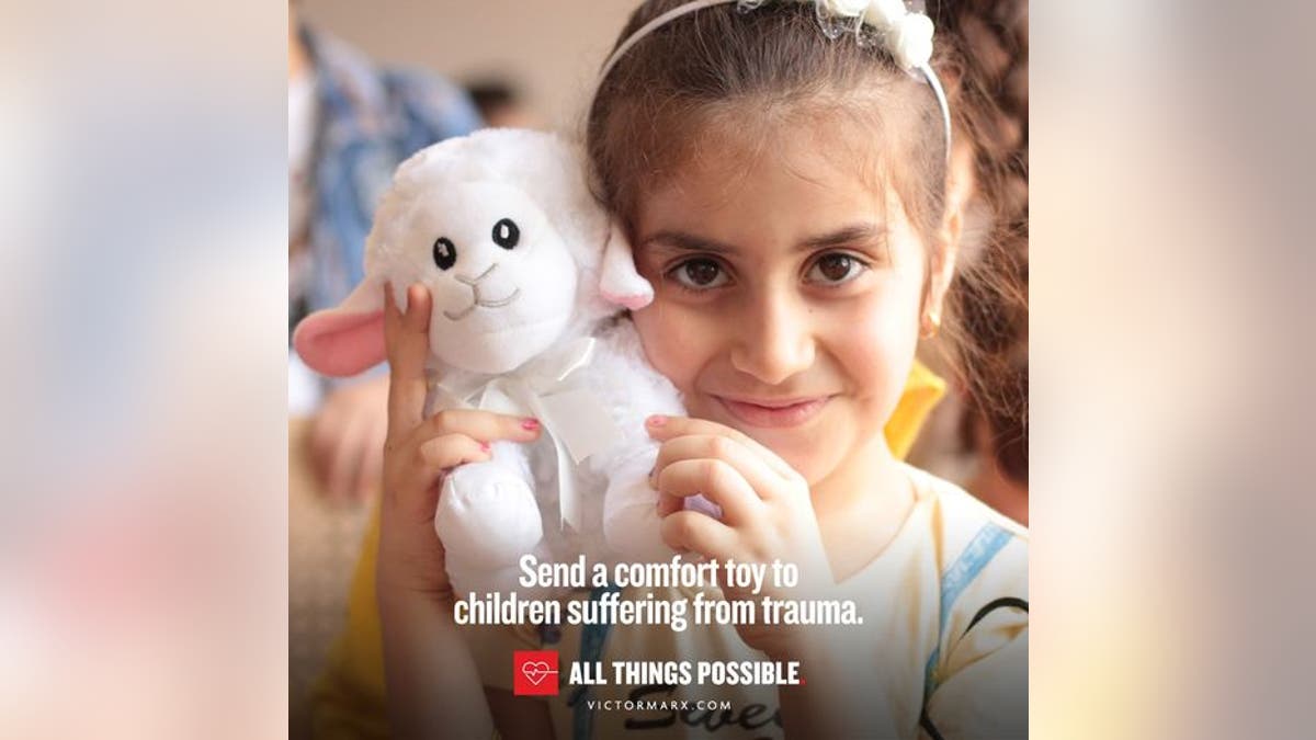 Image of little girl holding lamb toy