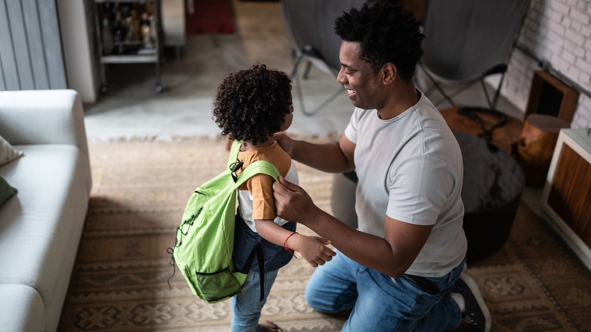 Man helping daughter