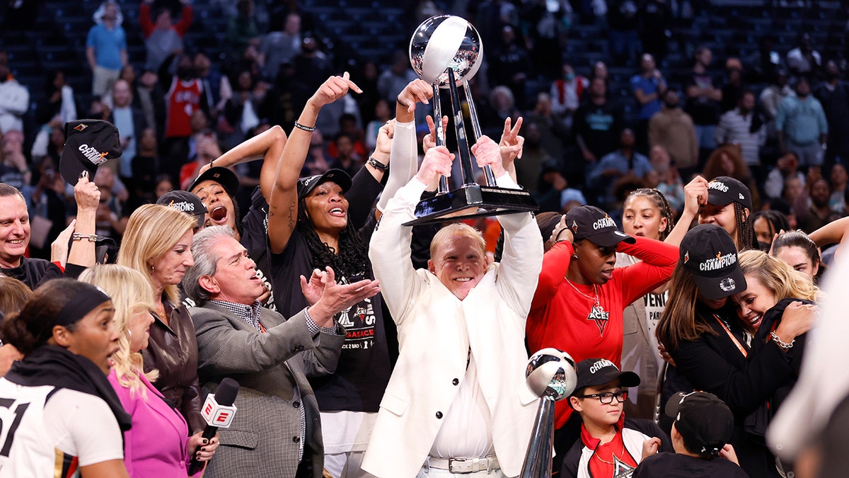 Mark Davis holds the WNBA championship trophy