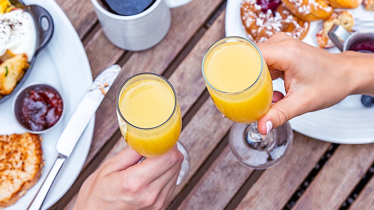 cheers with mimosa