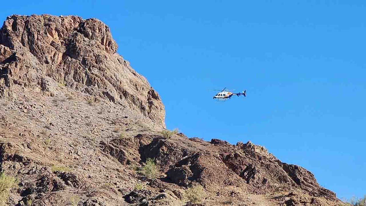 helicopter flying near peak