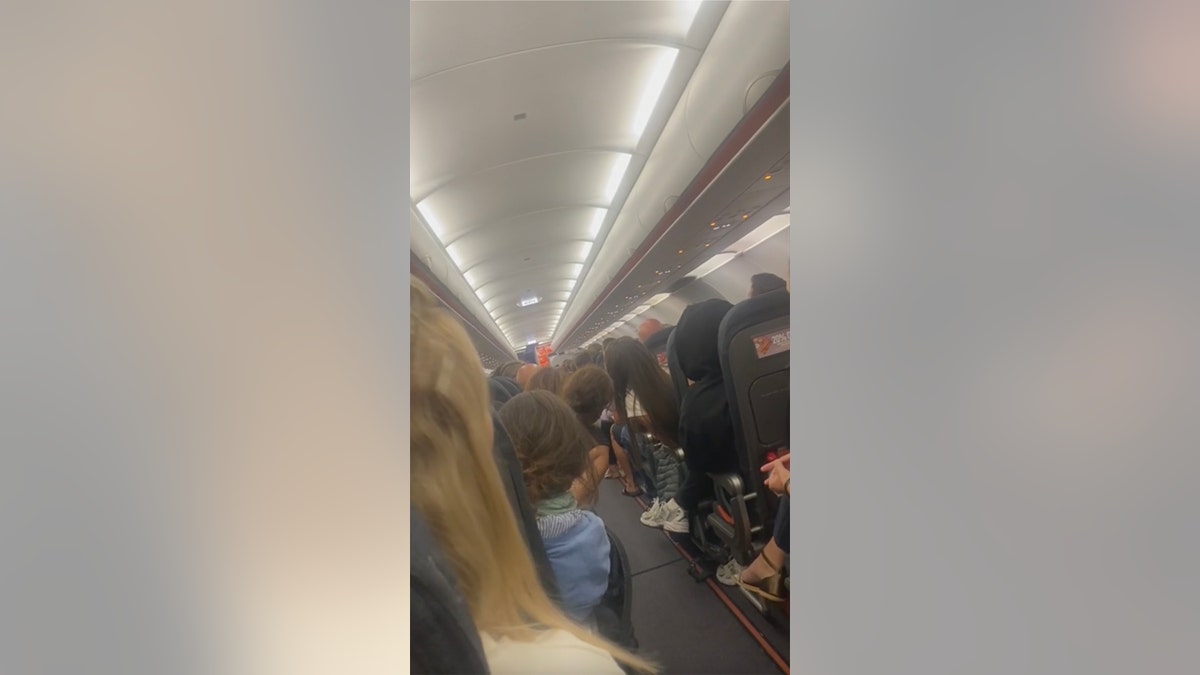 passengers listen to pilot make announcement