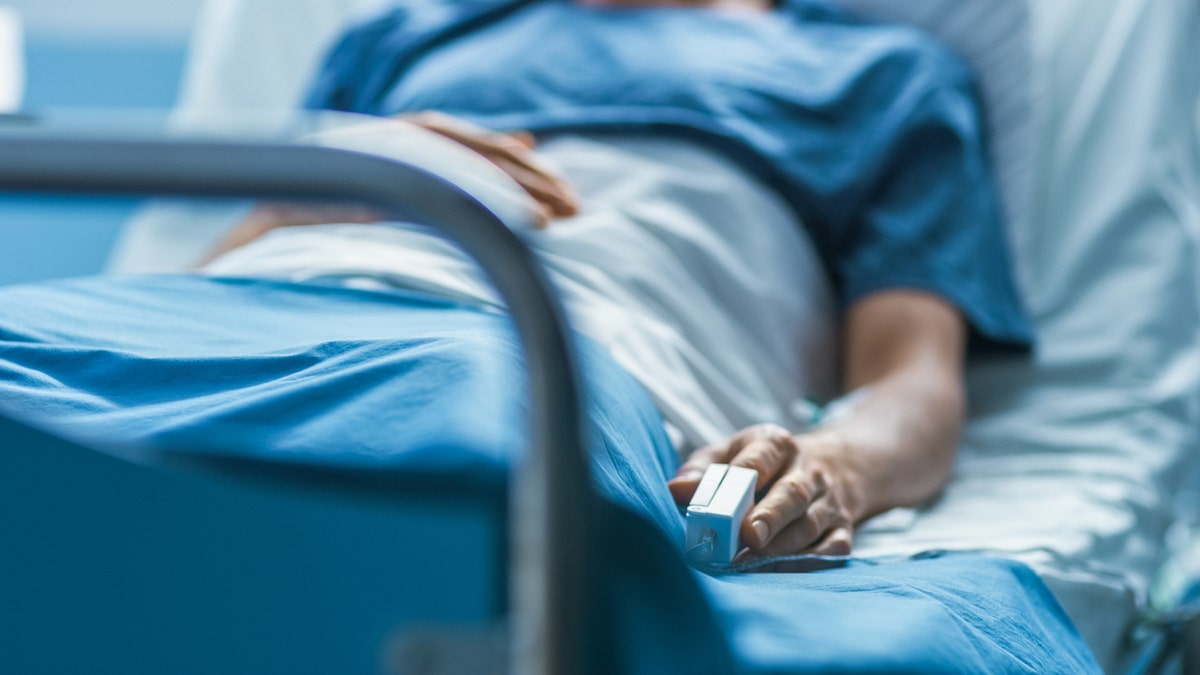 Person lying in hospital bed