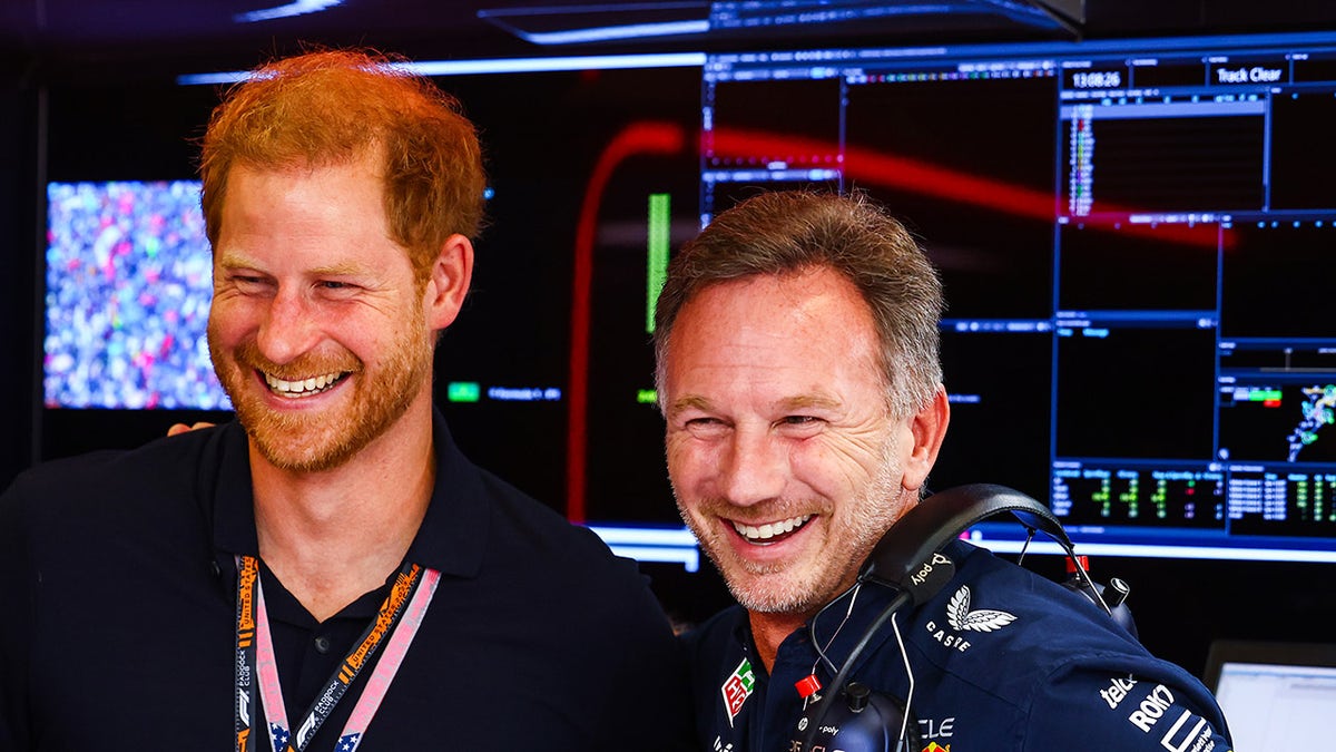 Prince Harry laughs with Christian Horner at Formula One Race
