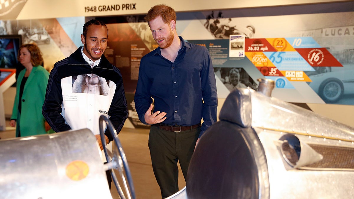 Prince Harry and Lewis Hamilton discuss race cars at museum