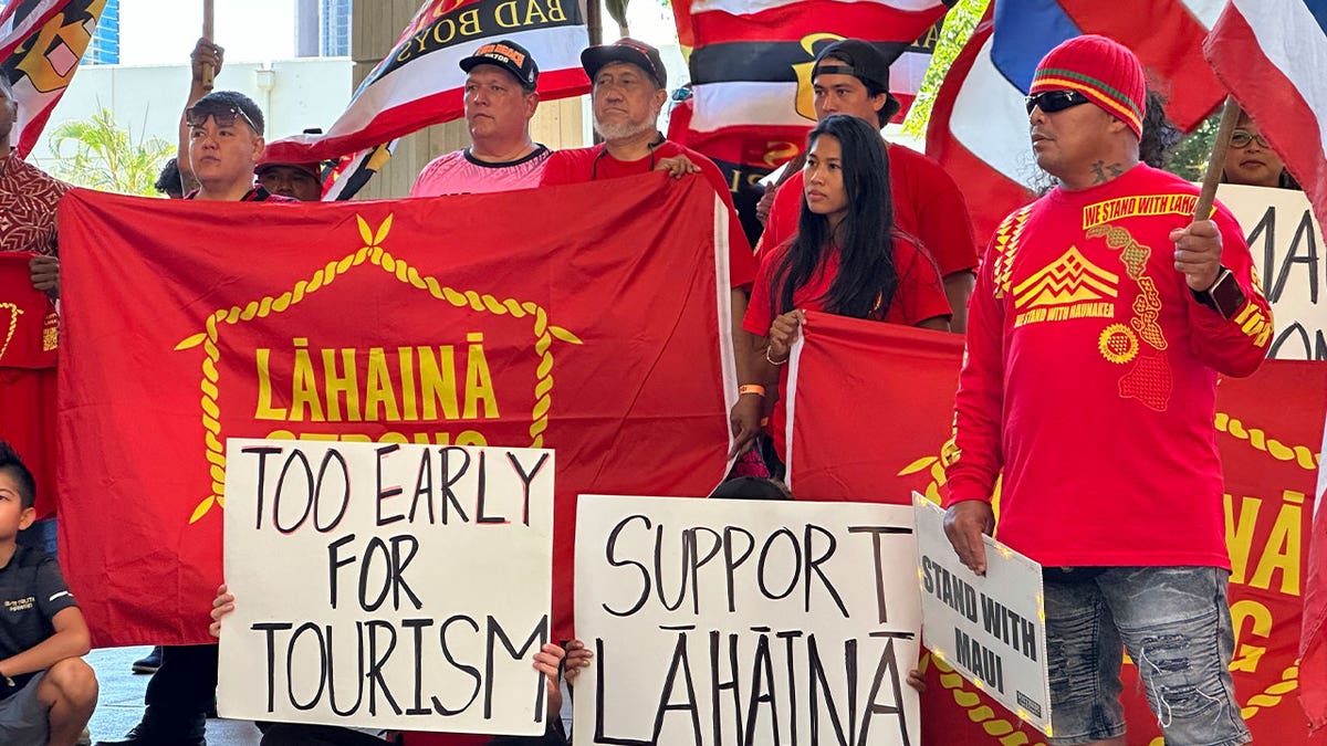 people hold signs and flags in a demonstration