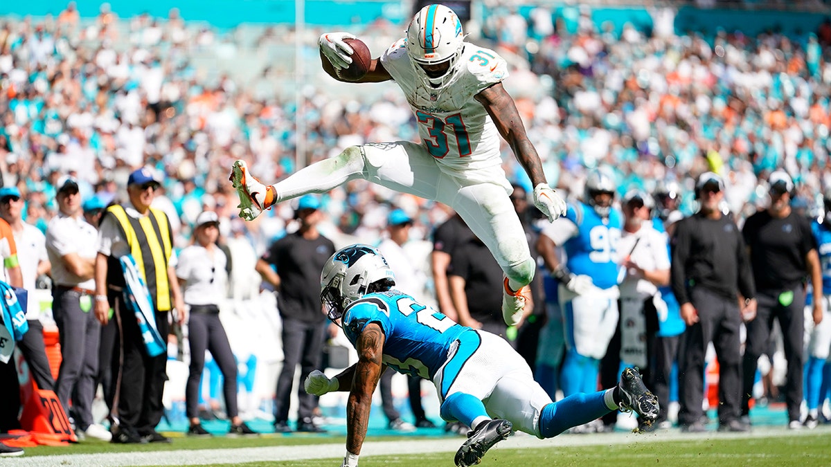 Raheem Mostert jumps over a player