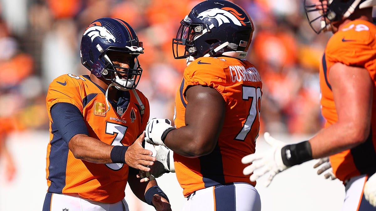 Russell Wilson high fives lineman