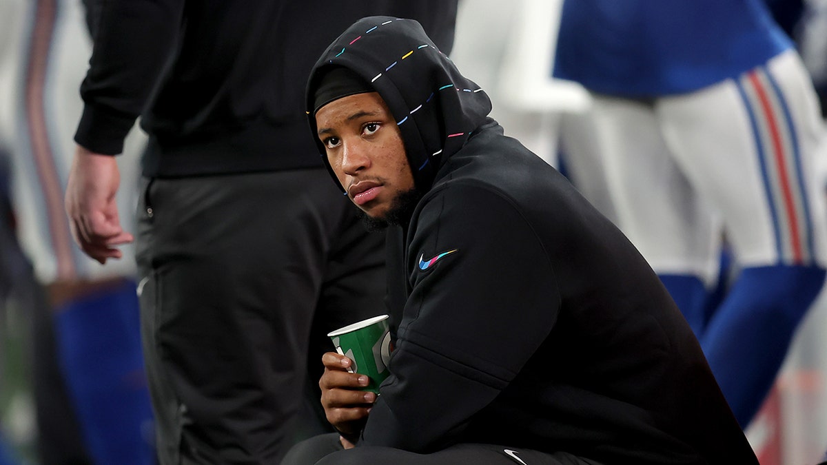 Saquon Barkley sits on the sideline