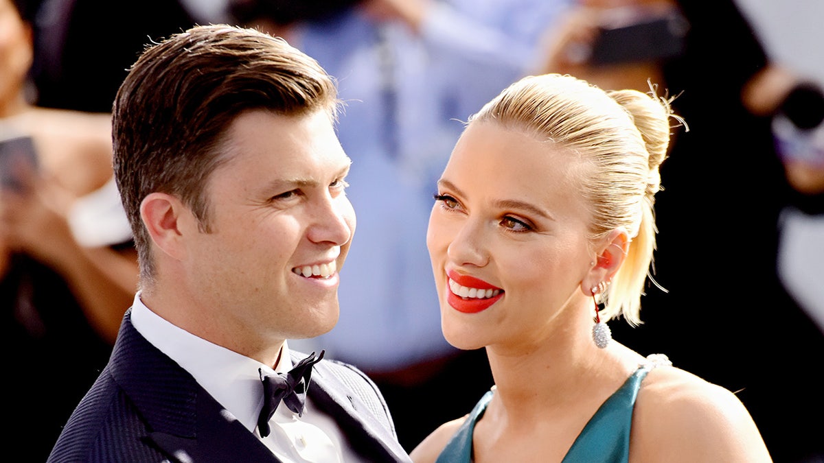 Scarlett Johansson smiling at Colin Jost