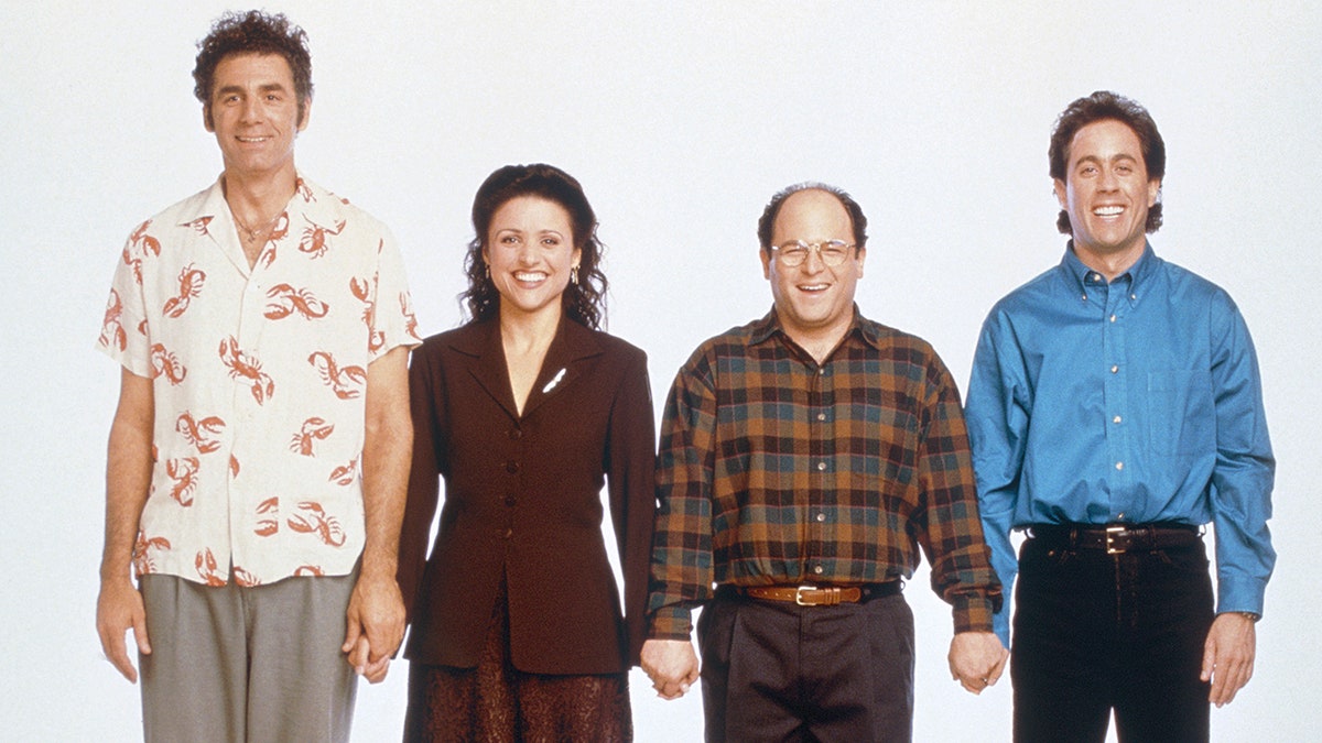The cast of "Seinfeld" hold hands in a promotional shot