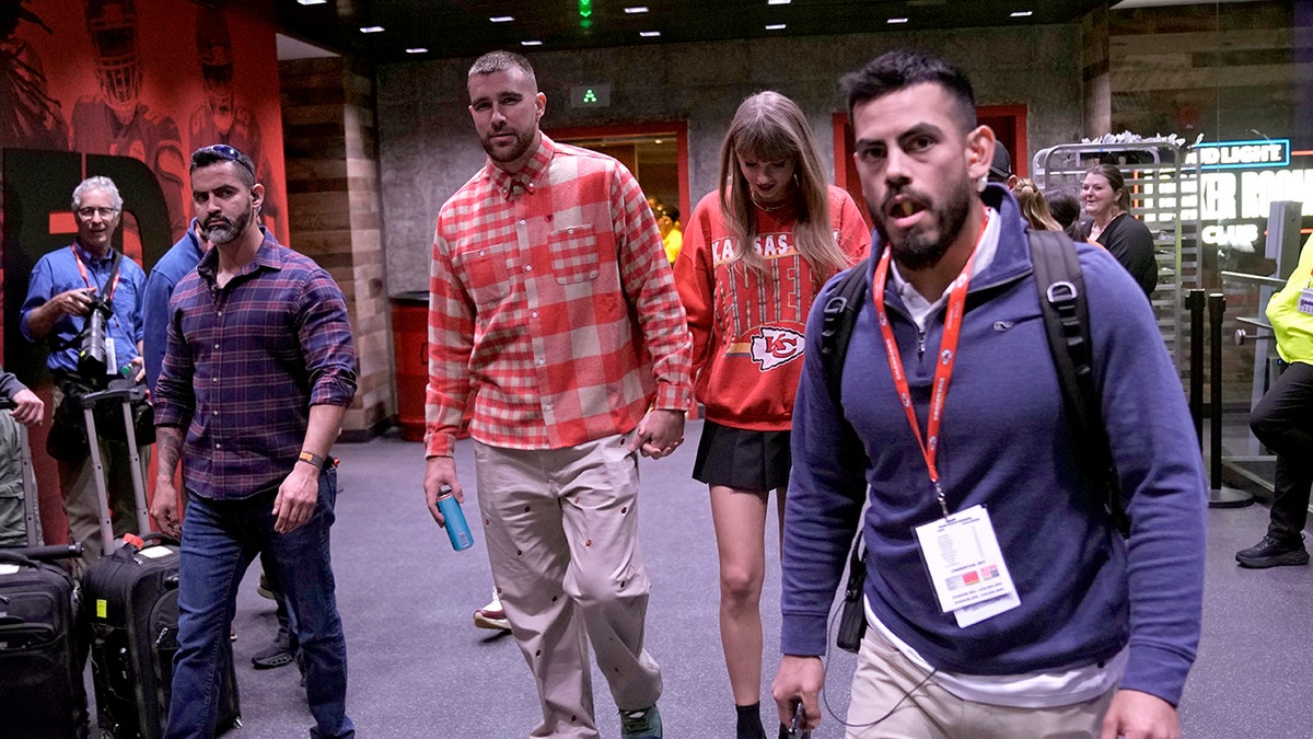 Travis Kelce and Taylor Swift holding hands