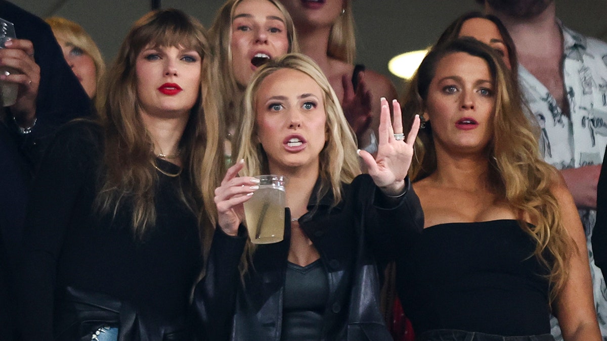 Taylor Swift parece perplexa quando Brittany Mahomes levanta a mão e Blake Lively parece chocado ao assistir o Kansas City Chiefs jogar contra o New York Jets em uma suíte no estádio MetLife