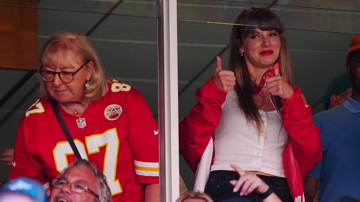 Taylor Swift makes a thumbs up in the Chiefs suite next to Donna Kelce