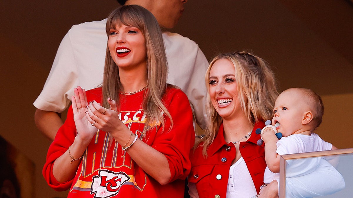 Taylor Swift claps during Kansas City Chiefs game with Brittany Mahomes