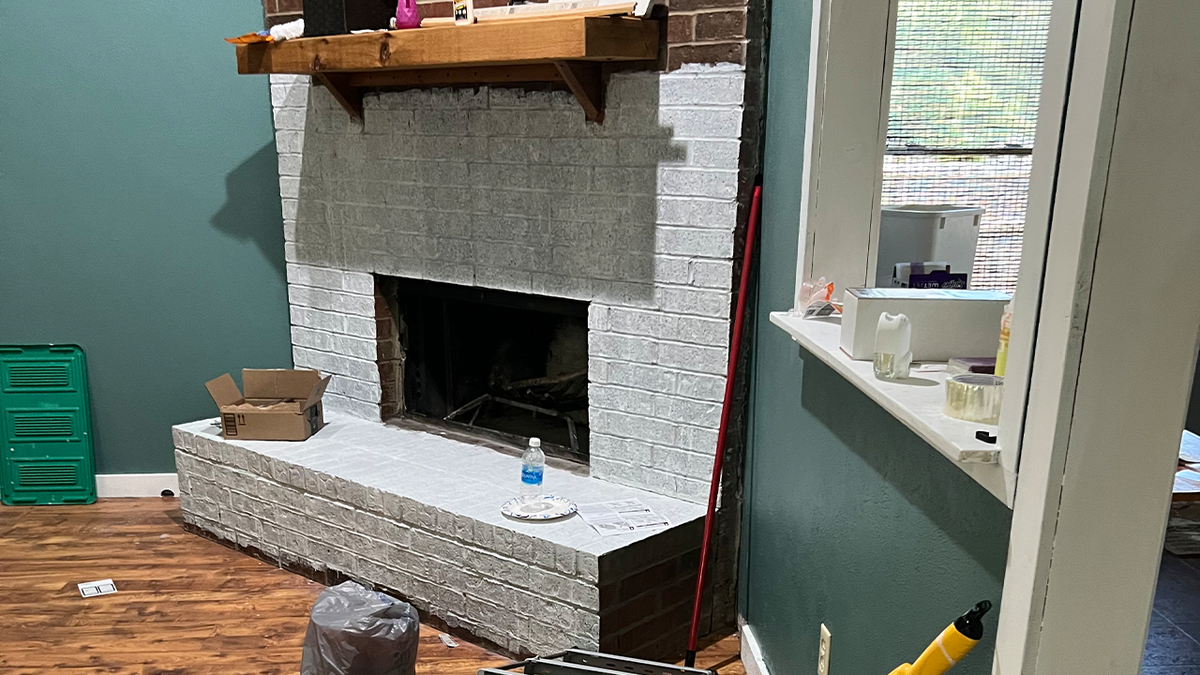 Whitewashed fireplace in squatter house