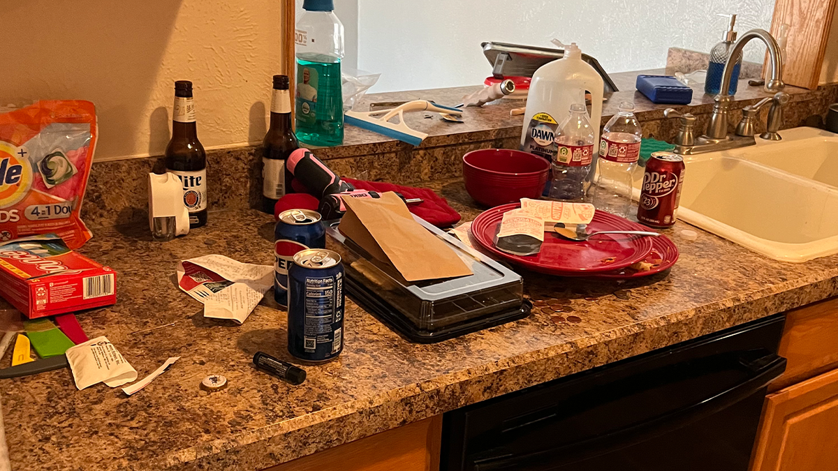 Mess on kitchen counter in squatter house