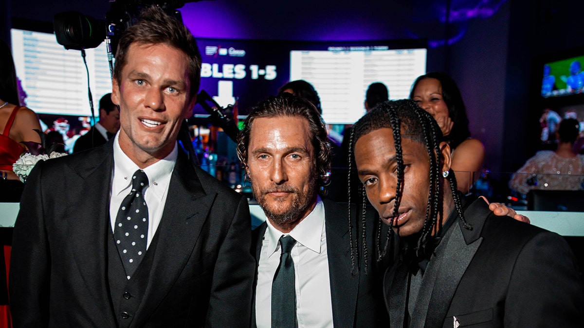 Matthew McConaughey wears suit and tie with Tom Brady and Travis Scott