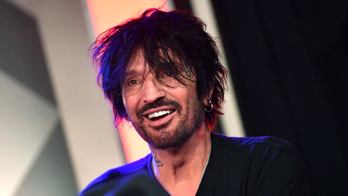Tommy Lee smiles on air