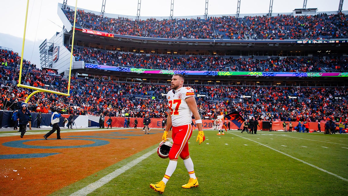 Travis Kelce walks off the field at Mile High
