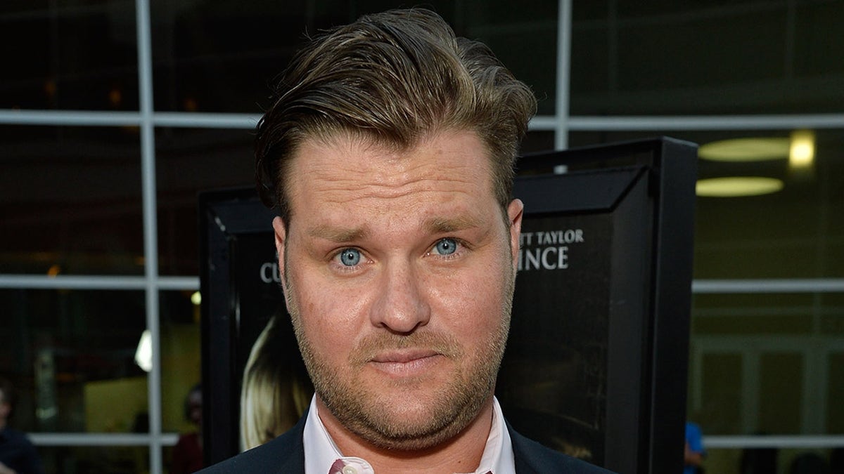 Zachery Ty Bryan attends premiere wearing suit