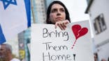 Woman holding sign